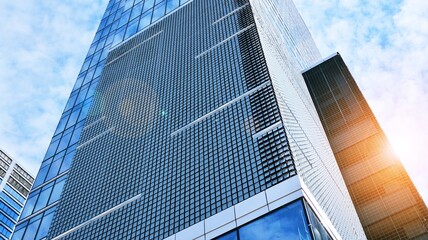 Downtown corporate business district architecture. Glass reflective office buildings against blue sky and sun light. Economy, finances, business activity concept. Rising sun on the horizon. Velvia gra © Grand Warszawski