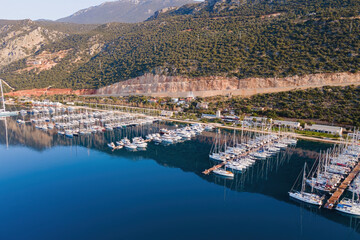 Obraz premium Aerial view of city marina or port with yachts and boats docked on a calm warm summer morning.