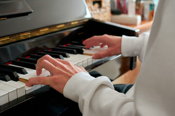A selective focus shot of hands playing the piano
