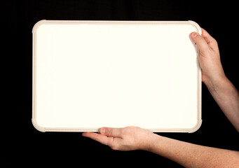 Whiteboard in Man's Hands on Black Background