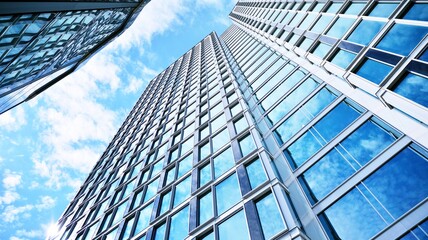 Bottom view of modern skyscrapers in business district against blue sky. Looking up at business buildings in downtown. Velvia graphic filter.