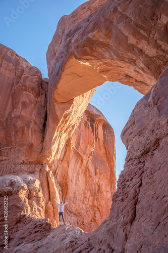 Person at Double Arch in Arches National Park