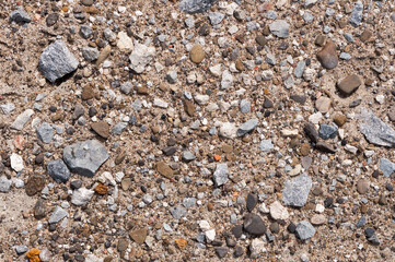 field of small grey gravel and grit on brown sand