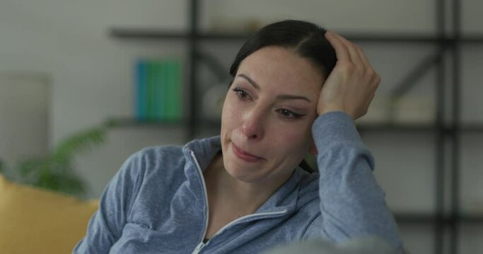 Sad woman crying at home alone