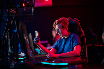 A cute gamer went live on twitch from a smartphone and shows the training process of gamers in a computer club