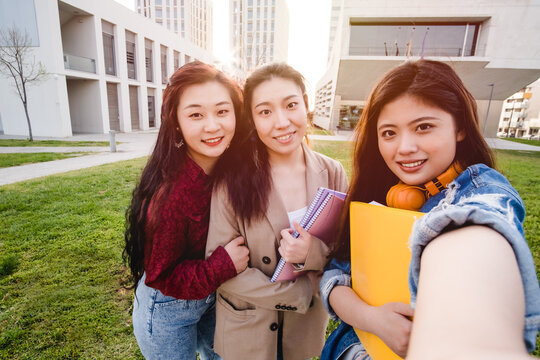 Three asian women taking a selfie. Student friends on the university campus