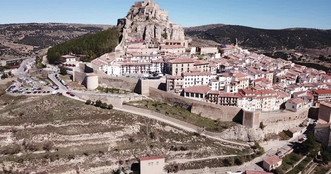 Aerial view of Morella cityscape with ancient fortified castle on top of rock in sunny day, Spain