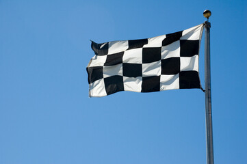 Checkered Finish Line Flag on Pole - Powered by Adobe