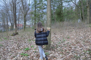 Girl on a walk in the forest, admiring dry flowers.	