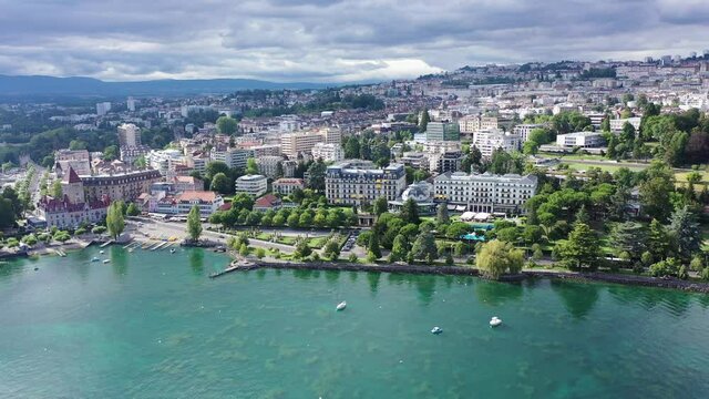 View from Lake Leman of residential areas of Swiss city of Lausanne in cloudy summer day, canton of Vaud in Romandy