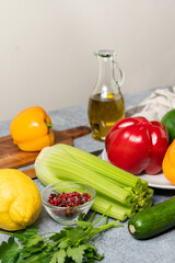 Healthy food fresh local vegetables red, green and yellow peppers, zucchini and celery in the hands of the chef. Vegetables for fresh salad with olive oil and lemon. Mediterranean diet vegan food