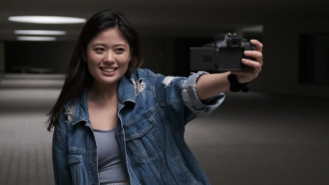 Asian woman vlogging and using camera, social media influencer content creator lifestyle
