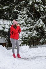 A young girl photographer taking photo of winter sports