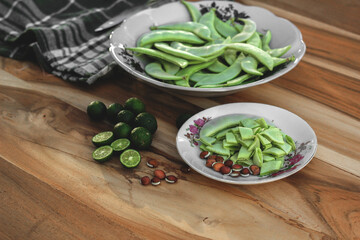 Lablab bean (Lablab purpureus) on a white plate and wooden table.
