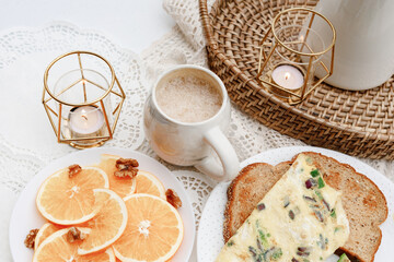 Avocado toast, oranges, coffee on Breakfast table in snow cover backyard feels like winter wonderland