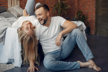 Couple sitting on a bed in a room