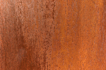 Smooth, slightly rough weathered and rusted orange-red colors surface with rust runs and rust spots. Detailed closeup Rusted metal sheet texture
