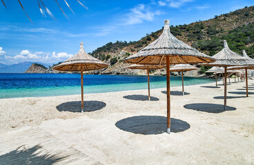An empty sandy beach with sun canopies near the Turkish resort of Fethiye during quarantine.