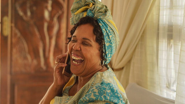 Elderly black woman talking on the phone