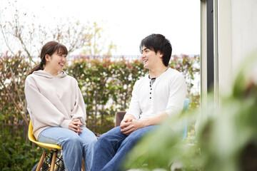 庭で雑談をするアジア人の夫婦