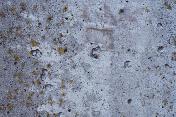 Background texture. Aged dark concrete surface with stones and moss. Top view. Copy space