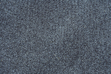 Background texture. Gray surface made of small stones, roofing felt. Copy space