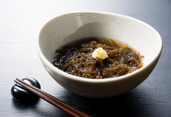 A mozuku seaweed placed on a black background.