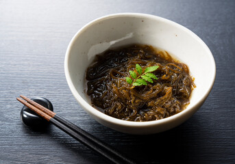 A mozuku seaweed placed on a black background.