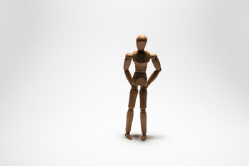 wooden mannequin standing on white background