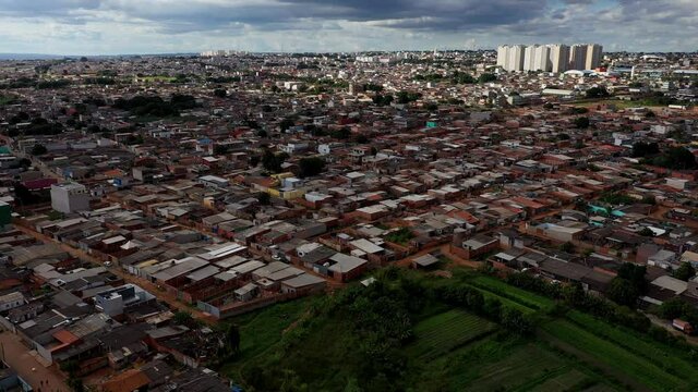 The Sol Nascente favela below and modern high-rise buildings in the distance - aerial view