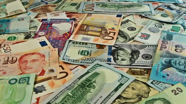 Cash money background closeup rotation. US dollar, euro, ruble, baht, peso, rupee banknotes