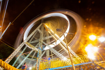 Long Exposure Shot of well illuminated and colorful Giant Ferris Wheel