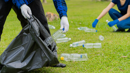 Collect plastic bottles on the grass in the park clean up the woods help environmental charity waste collection ideas