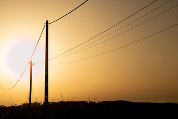 Fototapeta na wymiar electric poles sunset two