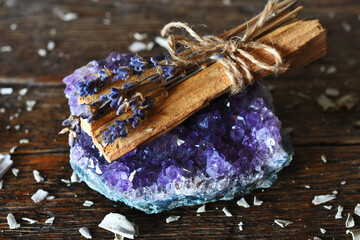 A close up image of sacred smudge stick with dried lavender and amethyst. 