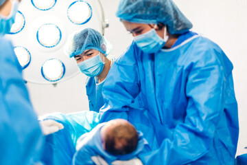 Professional anesthesiologist doctor medical team and assistant is performing baby cesarean section...