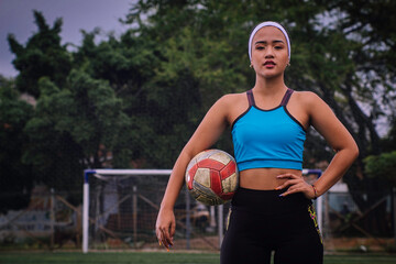 Woman with soccer ball under her armband