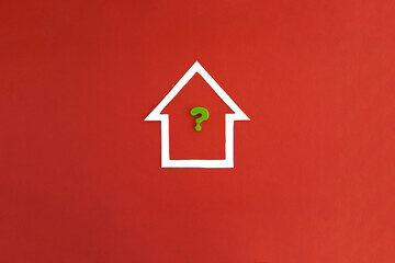 Obraz na płótnie Canvas The house is white, the question mark is green on a red background. Determining the cost of housing. The real estate market.