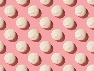 A seamless pattern of whipped meringue on a pink background.