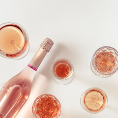Rose wine assortment in crystal glasses, bottle of rose champagne sparkling wine. Summer alcoholic drink