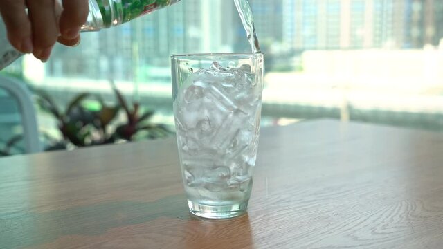 pouring water in iced glass