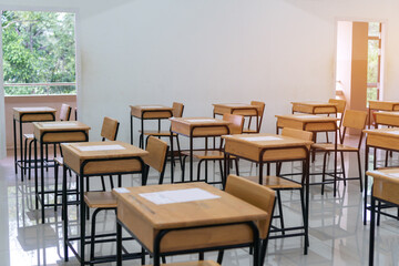School empty classroom with test sheet or exams paper on desks chair wood at high school thailand, Empty classroom no childrens when COVID-19 disease outbreak and closed quarantine