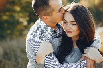 Beautiful couple spend time in a summer park