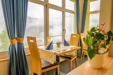 Modern dining room in luxury restaurant with fantastic swiss alps mountain view.