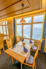 Modern dining room in luxury restaurant with fantastic swiss alps mountain view.