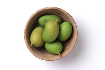 Tender mango on a white base for Indian style mango pickle.