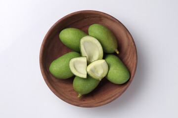 Tender mango on a white base for Indian style mango pickle.