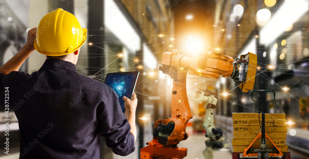Fototapete Engineer check and control automation robot arms machine in .modern warehouse industrial on real time monitoring system software. product inspection robotics. Network. Logistics and transportation