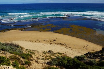 Sandstone by the beach under blue sky