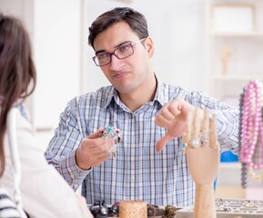 Woman visiting jeweler for jewelery evaluation